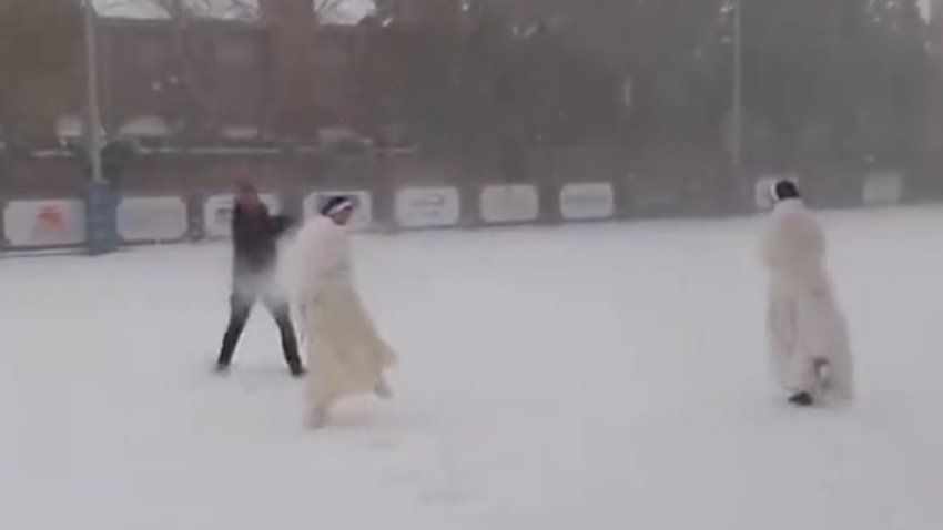 Nuns and a priest playing a snow fight in Louisiana.