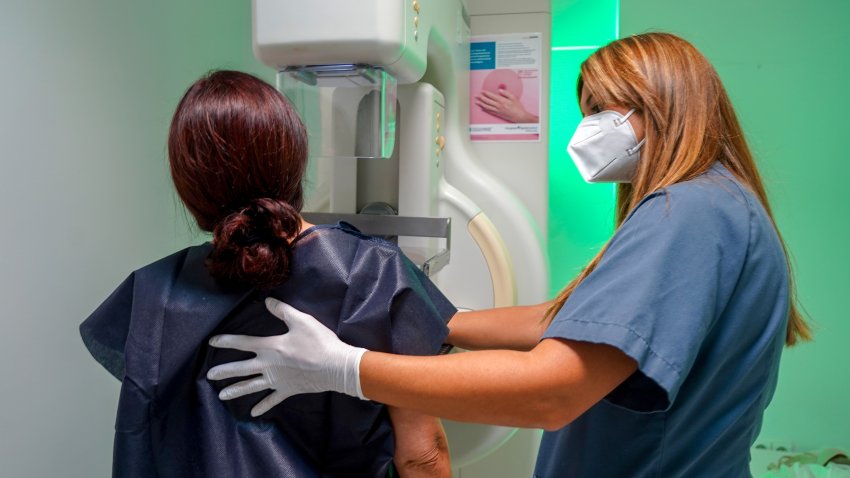 A lady with the help of a nurse gets a free mammogram at Quironsalud Infanta Luisa for the International Breast Cancer Day on October 19, 2021 in Seville, Andalusia.