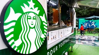 An employee services in a Starbucks coffee truck at Wuhan International Plaza on October 6, 2022 in Wuhan, Hubei province, China.