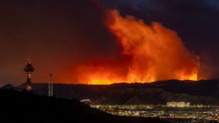 The Hughes Fire grows near Six Flags Magic Mountain amusement park and the community of Santa Clarita on January 22, 2025 in Castaic, California.