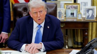 U.S. President Donald Trump looks on as he signs an executive order in the Oval Office at the White House in Washington, U.S., Jan. 31, 2025.