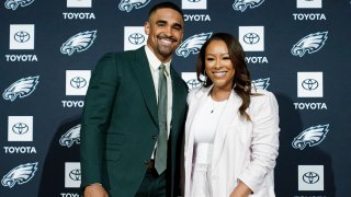 Philadelphia Eagles quarterback Jalen Hurts and agent Nicole Lynn pose for photographs at the NFL football team’s training facility in Philadelphia, Monday, April 24, 2023.
