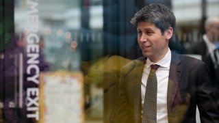 Sam Altman, CEO of OpenAI, at Station F, is seen through glass, during an event on the sidelines of the Artificial Intelligence Action Summit in Paris, France, Feb. 11, 2025.