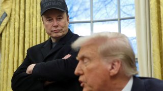 FILE PHOTO: Elon Musk listens to U.S. President Donald Trump speak in the Oval Office of the White House in Washington, D.C., U.S., February 11, 2025.   REUTERS/Kevin 
