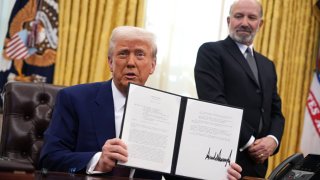 U.S. President Donald Trump, joined by Secretary of Commerce Howard Lutnick, delivers remarks after signing an executive order on reciprocal tariffs in the Oval Office at the White House on February 13, 2025 in Washington, DC. 