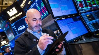Traders work on the floor of the New York Stock Exchange on Feb. 13, 2025.