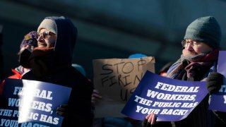 Protesters demonstrate in support of federal workers outside of the U.S. Department of Health and Human Services on Feb. 14, 2025 in Washington, DC.