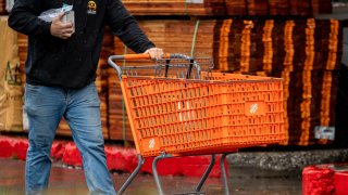 A customer pushes a shopping cart outside a Home Depot store in Palo Alto, California, US, on Monday, Nov. 11, 2024.