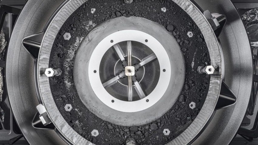 This image provided by NASA shows a top-down view of the OSIRIS-REx Touch-and-Go-Sample-Acquisition-Mechanism (TAGSAM) head with the lid removed, revealing the remainder of the asteroid sample inside. (NASA via AP)