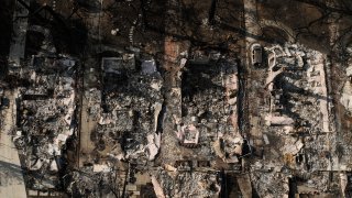 An aerial photo shows the charred homes of Louise Hamlin, center left, and Chris Wilson, center right, after the Eaton Fire in Altadena, Calif., Thursday, Jan. 30, 2025.