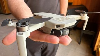 FILE – Seth Simonson, assistant professor/UAS curriculum lead for the North Dakota State College of Science, holds a Chinese-manufactured drone the college mainly uses for pilot training and photo and video collecting by students, Jan. 15, 2025, at the state Capitol in Bismarck, N.D.
