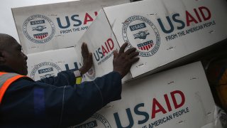Workers unload medical supplies to fight the Ebola epidemic from a USAID cargo flight in Harbel, Liberia, in 2014.