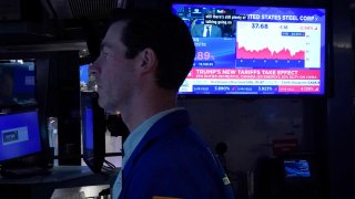 Traders work on the floor of the New York Stock Exchange (NYSE) in the Financial District in New York City on March 4, 2025.