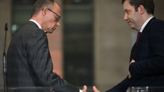 Leader of Germany’s Christian Democratic Union (CDU) Friedrich Merz (L) and Germany’s Social Democratic Party (SPD) Chairman Lars Klingbeil shake hands after delivering a press conference on planned major investments, in Berlin, on March 4, 2025.