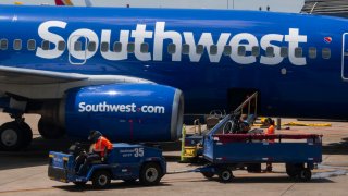 Baggage handlers load luggage onto a Southwest Airlines Boeing 737 at Austin-Bergstrom International Airport on August 24, 2024 in Austin, Texas.