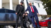 U.S. President Donald Trump talks to the media, next to Tesla CEO Elon Musk with his son X Æ A-12, at the White House in Washington, D.C., U.S., March 11, 2025. 