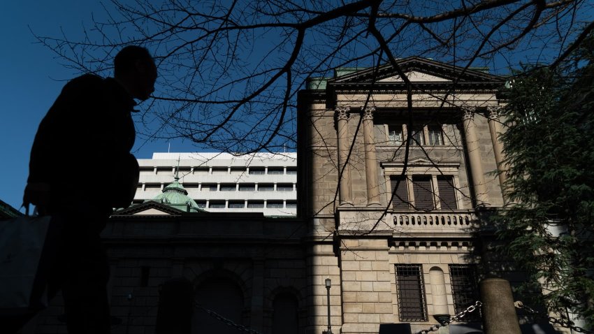 A pedestrian walks past the Bank of Japan headquarters on January 24, 2025 in Tokyo, Japan.