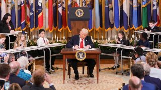 U.S. President Donald Trump signs an executive order to shut down the Department of Education, during an event in the East Room at the White House in Washington, D.C., U.S., March 20, 2025.