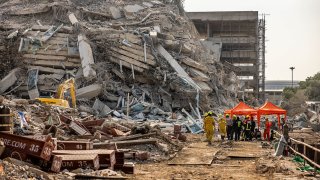 Thai rescue workers arrive on scene at a construction building collapse in the Chatuchak area following an earthquake on March 28, 2025 in Bangkok, Thailand. 