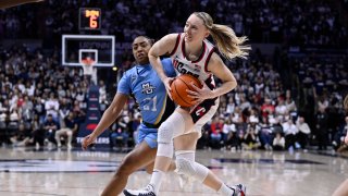 UConn guard Paige Bueckers, right,drives to the basket as Marquette guard Kennedi Perkins (21) defends during the second half an NCAA college basketball game, Sunday, March 2, 2025, in Storrs, Conn.