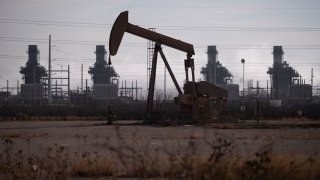 A pump jack operates near a gas turbine power plant in the Permian Basin oil field outside of Odessa, Texas, U.S. February 18, 2025.