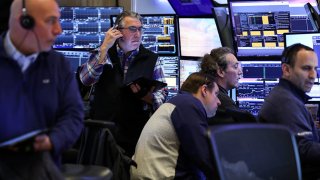 Traders work on the floor of the New York Stock Exchange (NYSE) at the opening bell on April 10, 2025, in New York City.