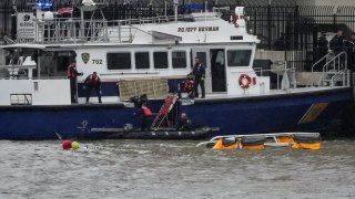 Rescue workers and emergency personnel work at the scene of a helicopter crash on the Hudson River near lower Manhattan in New York, U.S., as seen from Newport, New Jersey, April 10, 2025.