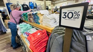 A woman shops for clothing from a Gap outlet store in Los Angeles, California on April 10, 2025. 