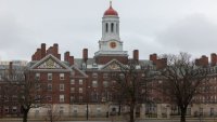 A person runs past Dunster House at Harvard University in Cambridge, Massachusetts, March 17, 2025.