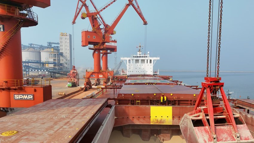 A crane unloads peas imported from Canada at the Laizhou port area of Yantai Port in Yantai, China, on February 28, 2025.