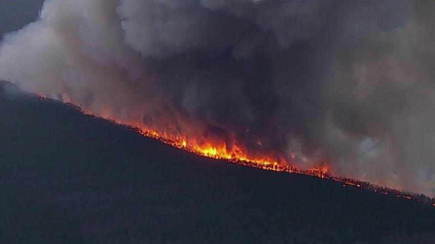 Evacuations, power outages and road closures as wildfires rage through NJ