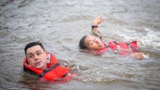 This image provided by the U.S. Army shows Capt. Seth Deltenre, left, and 1st Lt. Gabrielle White, from the Maneuver Center of Excellence in Fort Benning, Ga., as they compete in the “Run-Swim-Run” event during the 2025 Best Ranger Competition, April 11, 2025, at Victory Pond in Fort Benning.