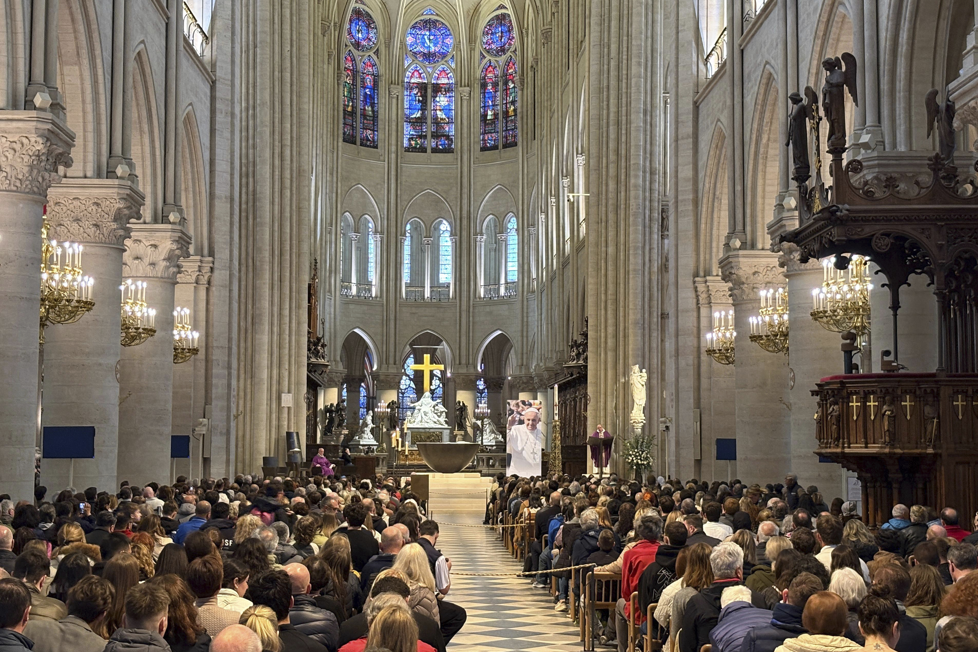 Worshippers attend a mass inside Notre Dame cathedral Monday, April 21, 2025 in Paris.