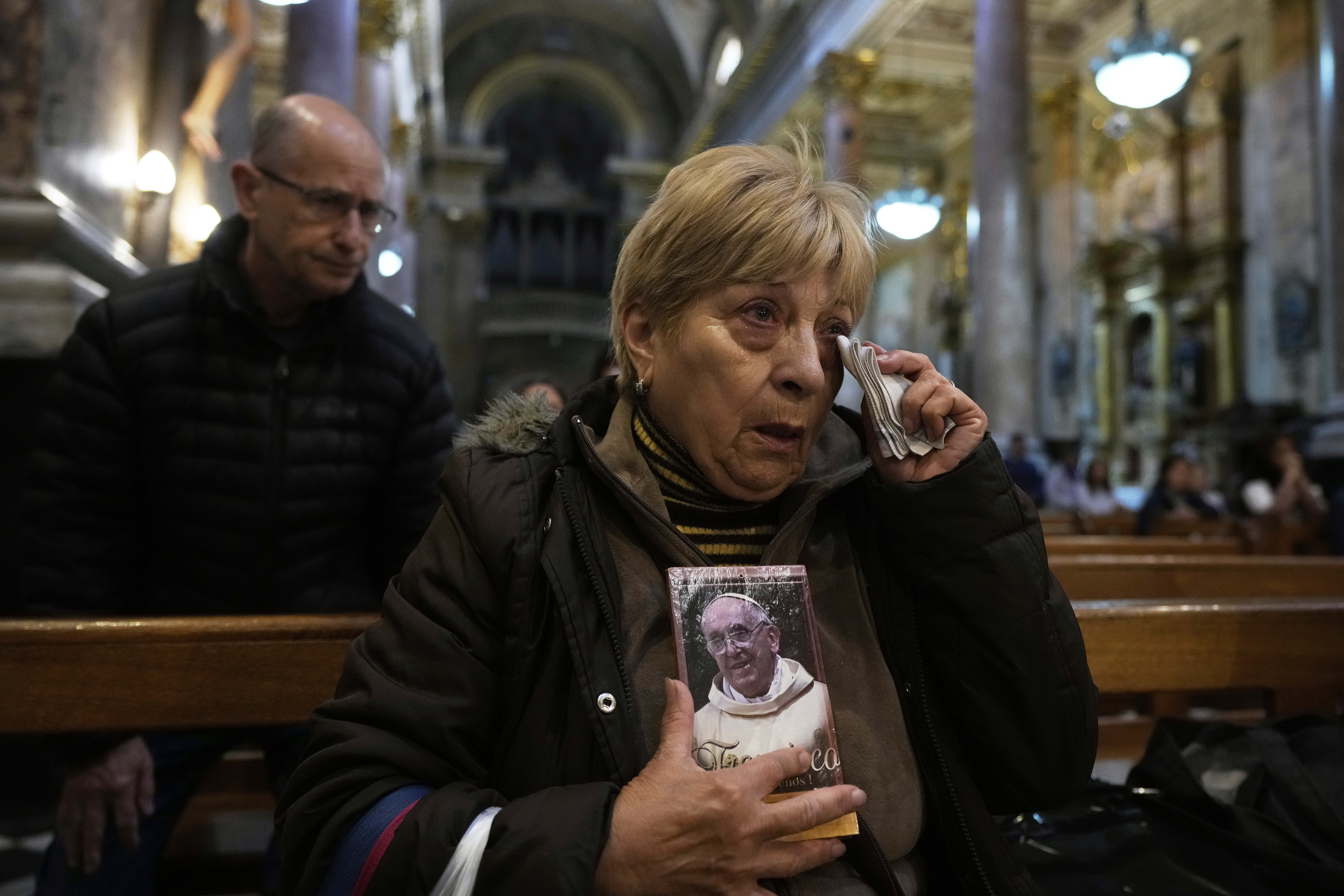 Maria Teresa Delgado  holds a portrait of the late Pope Francis during Mass at the Basílica de San José de Flores, where he worshipped as a youth, in Buenos Aires, Argentina, Monday, April 21, 2025.