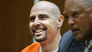 Gang member and convicted murderer Timothy McGhee laughs during sentencing in Los Angeles.