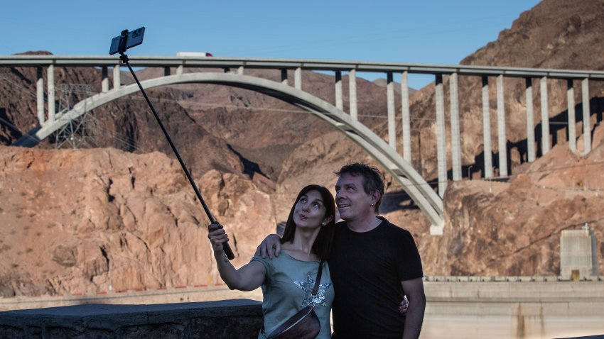 Visitors pose for a selfie at Lake Mead, the country’s largest man-made water reservoir, formed by the dam on the Colorado River in the Southwestern United States.