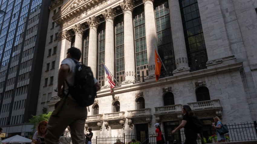 People walk by the New York Stock Exchange (NYSE) on June 18, 2024 in New York City. 