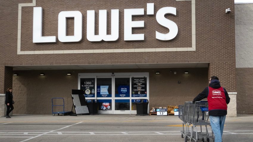 A worker collects shopping carts at a Lowe’s home improvement store on Feb. 26, 2025 in Chicago, Illinois.