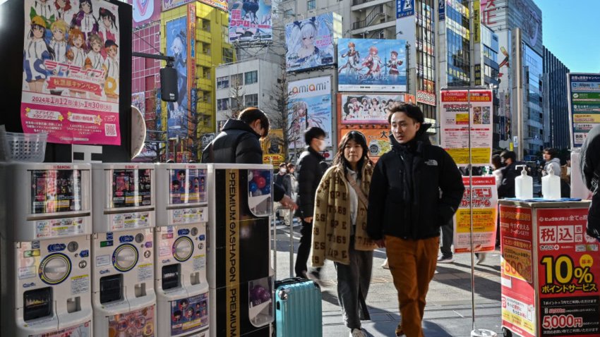 TOPSHOT – Customers enter an electronics shop in the Akihabara district of Tokyo on January 12, 2024. 