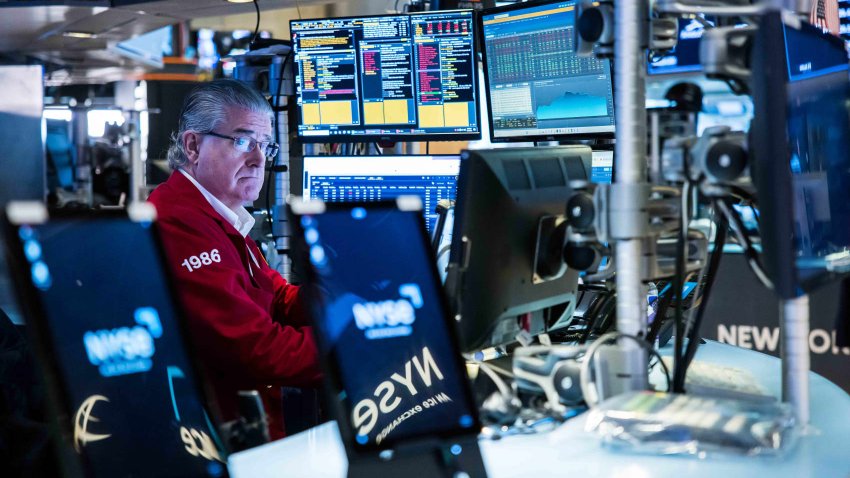 Traders work on the floor of the New York Stock Exchange on March 13, 2025. 