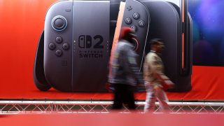 Attendees walk past an advertising board during the Nintendo Switch 2 Experience at the ExCeL London international exhibition and convention centre in London, Britain, April 11, 2025.