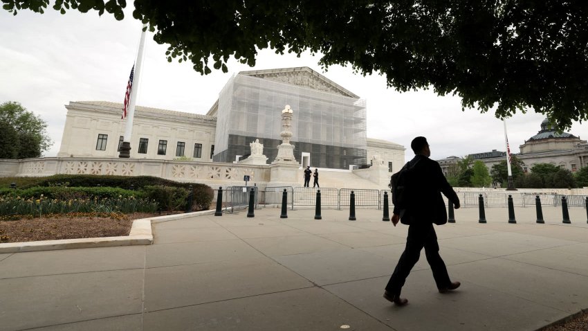 A person walks past the U.S. Supreme Court in Washington, D.C., U.S., April 21, 2025.