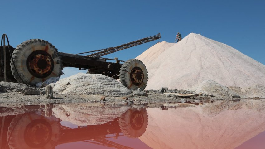 An employee works at a pink salt production site on Lake Sasyk-Sivash near Yevpatoria, on September 21, 2023.