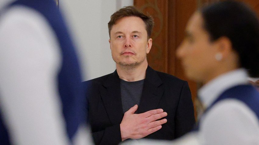 Tesla CEO Elon Musk holds his hand on his heart as the U.S. national anthem is played at a state dinner hosted by Qatar’s Emir Tamim bin Hamad Al Thani during a visit by U.S. President Donald Trump, at Lusail Palace in Lusail, Qatar, May 14, 2025.