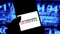 In this photo illustration, a Foxconn logo is seen displayed on a smartphone.