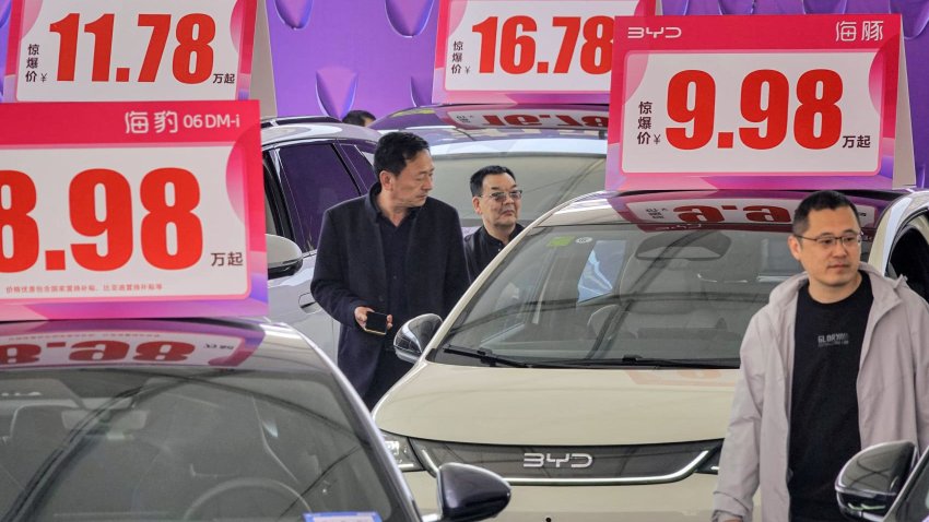 Customers look at BYD electric cars at an auto show in Yantai, in eastern China’s Shandong province on April 10, 2025.