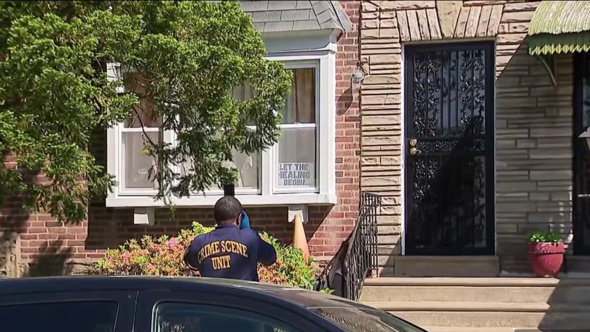 An officer investigates a home on the 1500 block of East Pastorius Street in Philadelphia after a 12-year-old boy was shot and killed in an incident there on Saturday, May 10, 2025.
