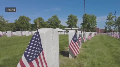 Volunteers honor fallen heroes by placing flags at State Veterans Cemetery in Middletown