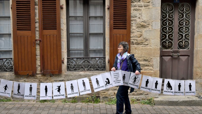A woman holds a banner representing anonymous victims during a demonstration ahead of the verdict in the trial of Joel Le Scouarnec, a 74-year-old former surgeon, accused of raping and sexually assaulting 299 children, Wednesday, May 28, 2025 in Vannes, Brittany, western France.
