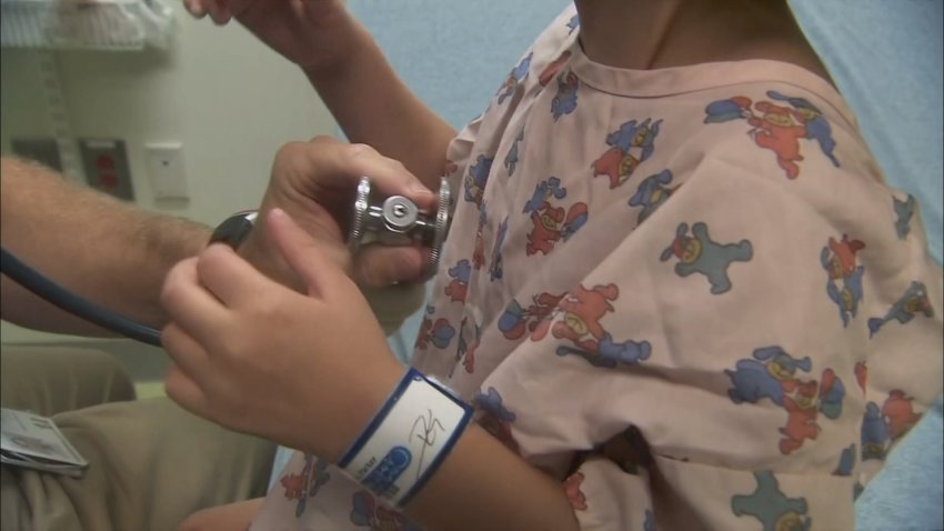 A doctor examining a child with whooping cough.
